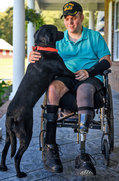 Jason Ehrhart and his service dog at home. 