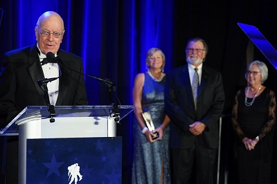 Bob Duke accepts The Service Award alongside Holly Williams, Dave Williams, and his wife Vicki Duke (left to right).