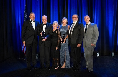 Service Award winners Bob Duke (second to left), Dave Williams (second to right), and Holly Williams (third from right) pose with CEO Lt. Gen. (Ret.) Mike Linnington (left), Bob’s wife Vicki Duke (third from left), and wounded warrior John Rego (right).