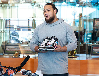 Denver Broncos DL Mike Purcell holds cleats he previously used to support Wounded Warrior Project for the NFL's My Cause, My Cleats campaign. Purcell recently picked WWP as his cause for the fourth year in a row.