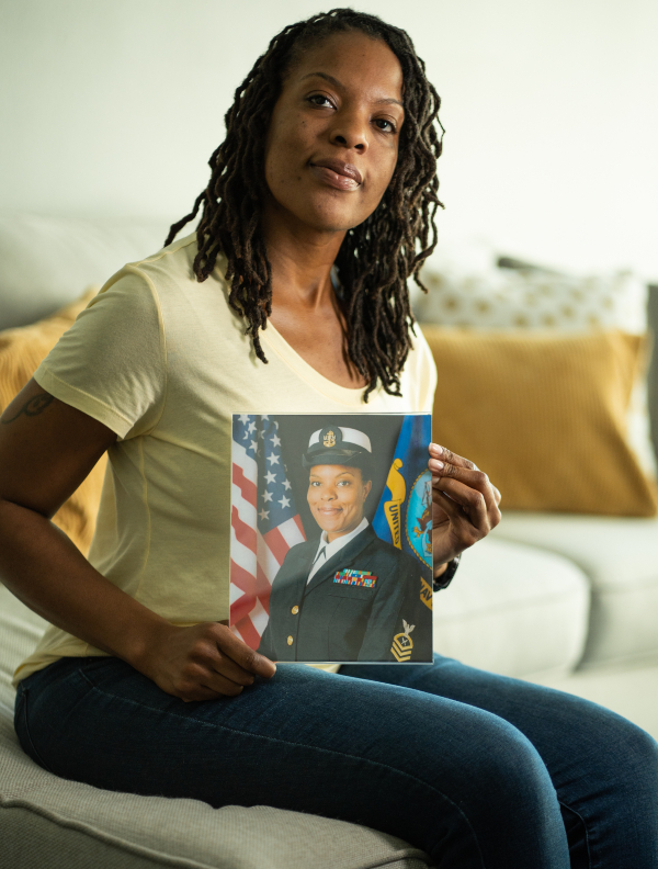 Sharona Young holds photo of herself in Navy uniform