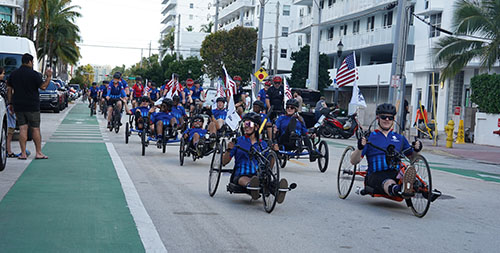 Warriors ride adaptive bicycles through the streets on Miami during Soldier Ride.