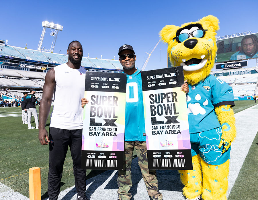 Jacksonville linebacker Devin Lloyd and Jaguars mascot Jaxson de Ville present Super Bowl tickets to WWP warrior 