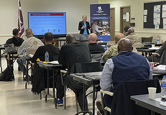 Military service members listen to a representative of WWP's Transition Ready Program.