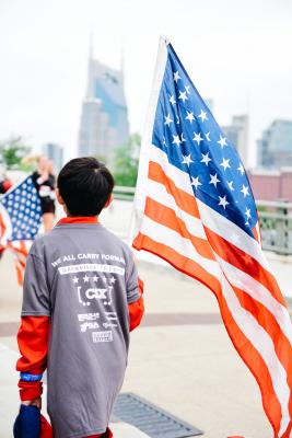 kid holding usa flag at wwp carry forward 5k