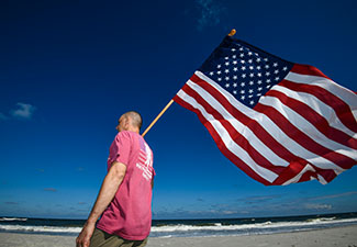 Participants in Wounded Warrior Project's Carry Forward event in Jacksonville, Florida, wave small flags in support of warriors. 